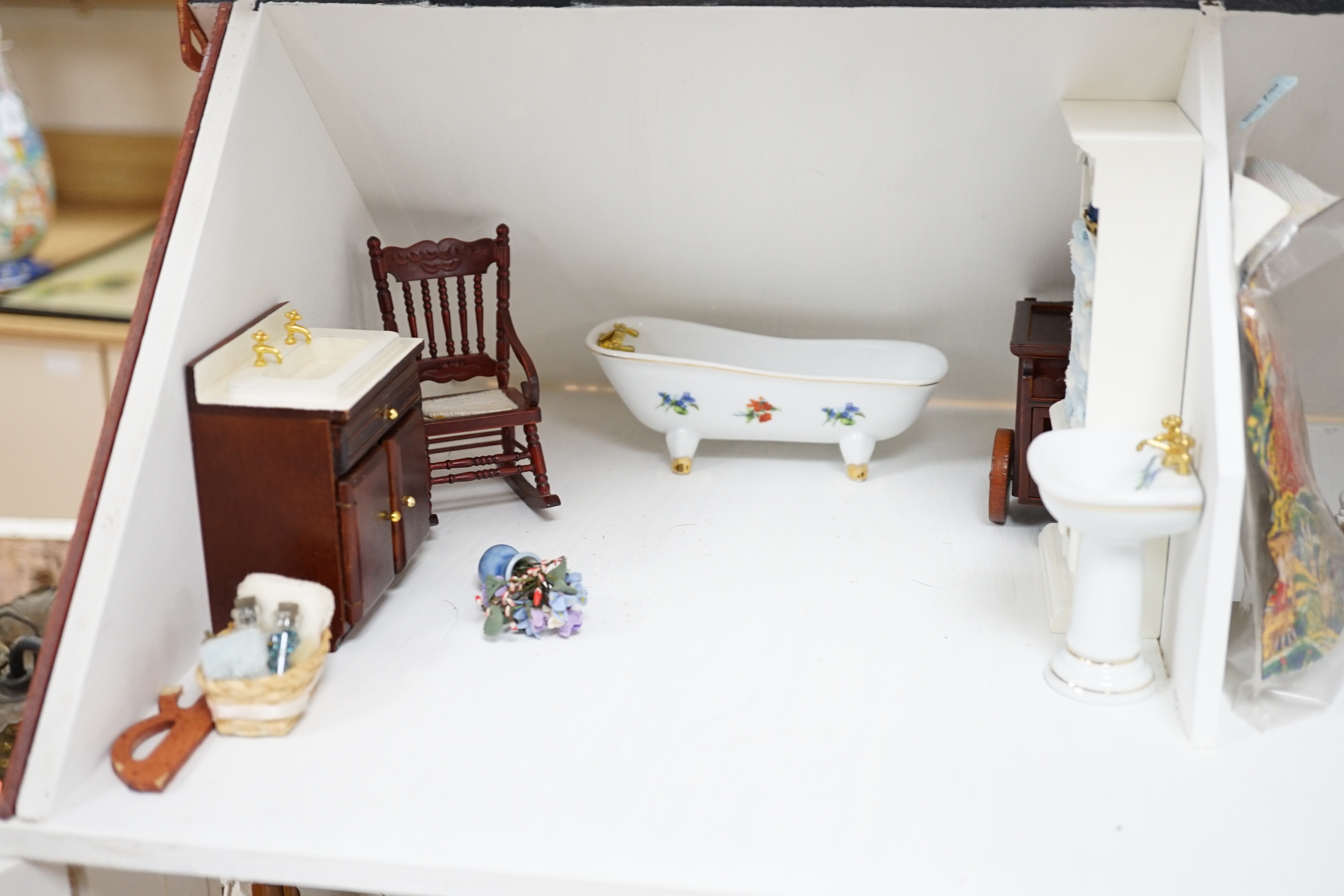 A painted doll's house with dolls and furniture, dolls house 78.5cm wide, 67cm high